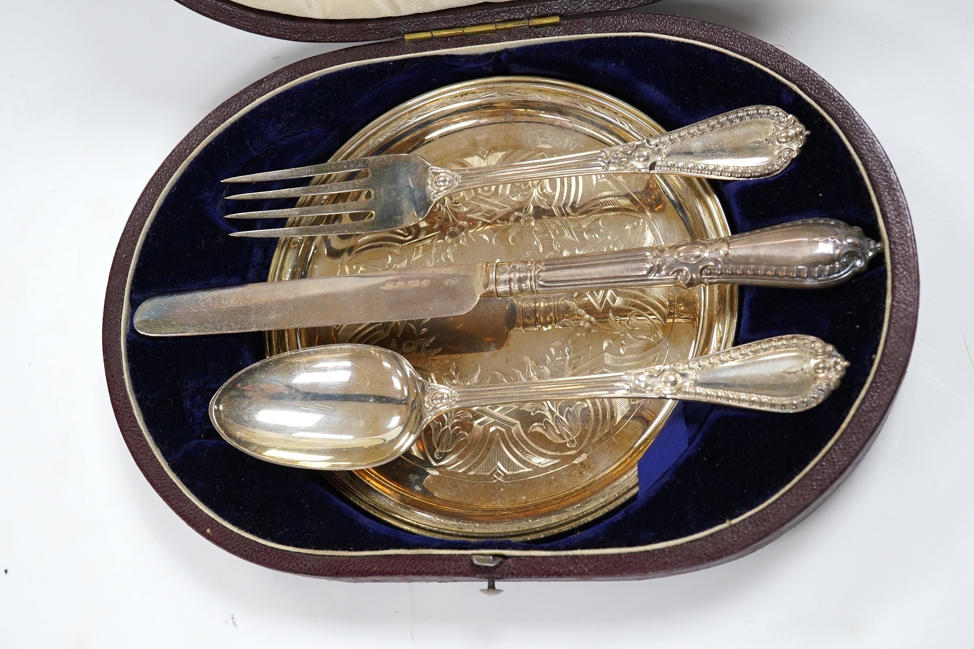 A cased Victorian silver four piece christening set, George Adams, London, 1853 and Henry Wilkinson, Sheffield, 1854. Condition - fair to good